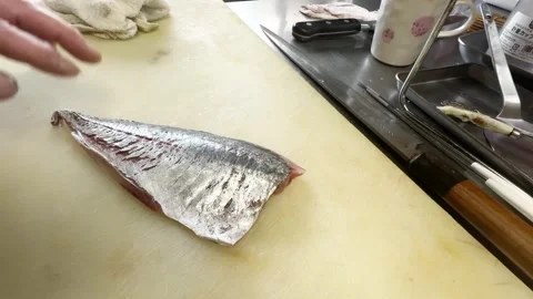 Chef showing both sides of a skinned horse mackerel fillet Stockbeeldmateriaal 339382077