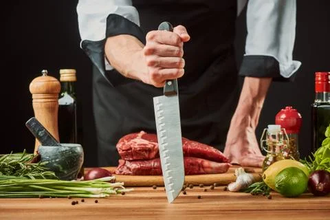 Chef showing off his sharp knife before cooking a beef steak Stock Photos
