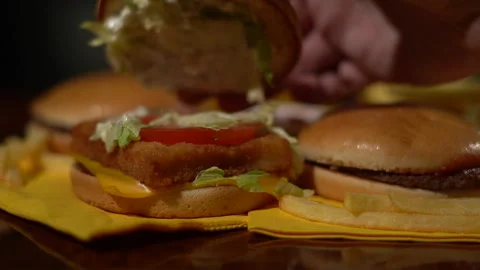 Chef showing the inside of a freshly prepared burger Stock Footage 260398241