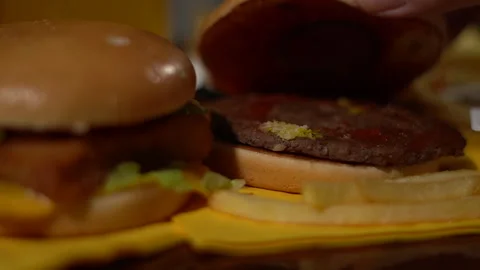 Chef showing the inside of a freshly prepared burger Stock Footage 260398538