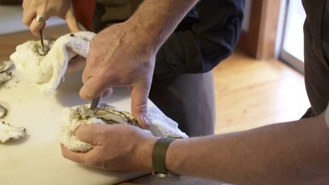 Chef showing a student how to open an oyster with a knife 스톡 동영상 77081711