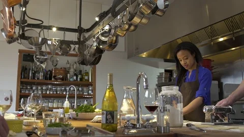 Chef showing a student how to use a dough roller Stock Footage 77081741