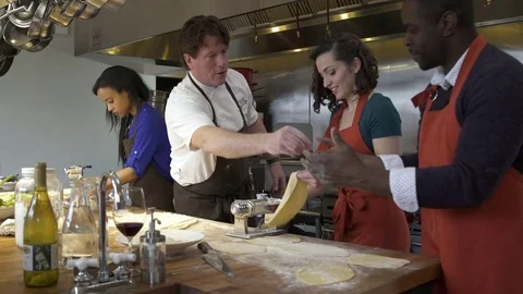 Chef showing students how to use a dough roller 動画素材 77081754
