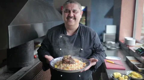 The chef shows on camera plate of pilaf with lamb. Stock Footage 65813177