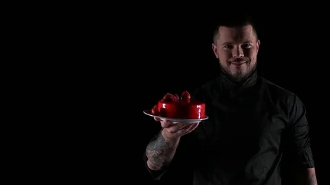 Chef shows dessert on a black background Stock Footage 69920403