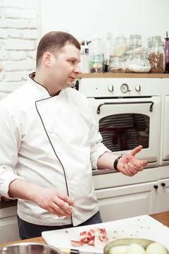 The chef shows a master class in the kitchen, shows the students a cooking Stock Photos