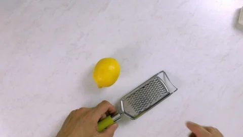 Chef shredding lemon with grater. Making Lemon Mascarpone Pie Series. Stock Footage 98808422