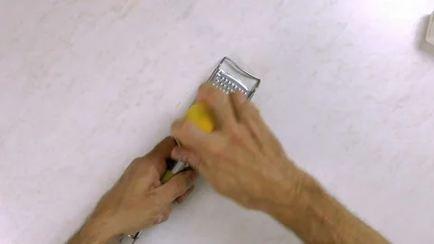 Chef shredding lemon with grater. Making Lemon Mascarpone Pie Series. Stock Footage 98808542
