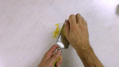 Chef shredding lemon with grater. Making Lemon Mascarpone Pie Series. Stock Footage 98808600