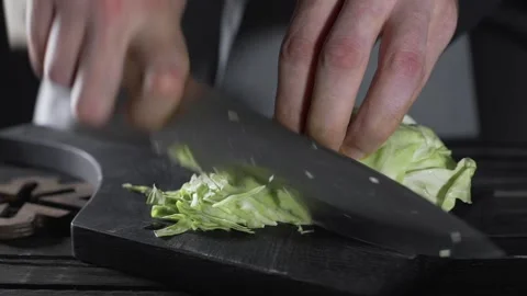 Chef shreds cabbage for vegetable salad Video stock 143779512