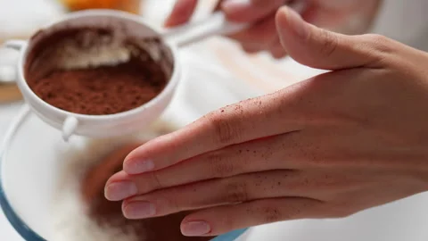 Chef is sifting cocoa through a bolter into glass bowl. Side view of the bak Stock Footage 247367404