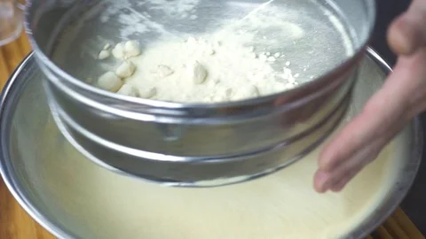 Chef sifting flour through sieve for baking close up. Male hand pouring flour Stock Footage 98483498