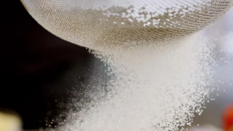 Chef sifting white wheat flour through metal sieve onto wooden kitchen table. Stock Footage 337484326