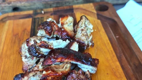 Chef skilfully cuts freshly BBQ Chicken meat into bite-size pieces Stock Footage 323487868