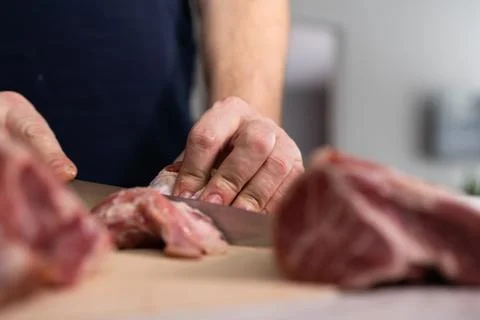 Chef Skillfully Prepares Meat in a Home Kitchen During a Morning Cooking Session Stock Photos