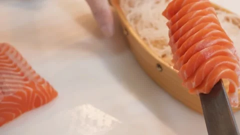 Chef Skillfully Slicing Fresh Salmon Fillet for Premium Japanese Sashimi Stock Footage 333489636