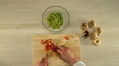 Chef skillfully slicing tomato. First person view Video stock 67944462
