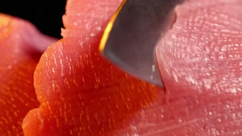 Chef slice a piece of raw beef. Close-up shot of meat slicing. Macro Stock Footage 147987153
