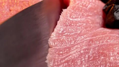 Chef slice a piece of raw beef. Close-up shot of meat slicing. Macro Stock Footage 147987183