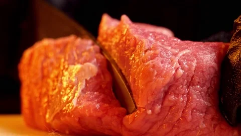 Chef slice a piece of raw beef. Close-up shot of meat slicing Stock Footage 147987256