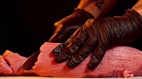 Chef slice a piece of raw beef. Close-up shot of meat slicing Stock Footage 147987323
