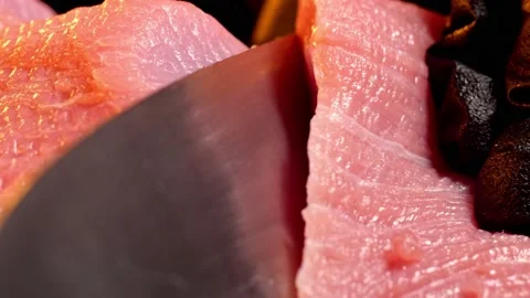Chef slice a piece of raw beef. Close-up shot of meat slicing. Macro Stock Footage 148124423