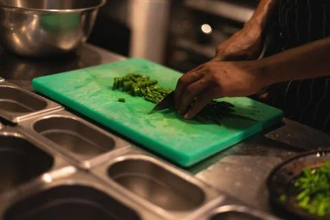 The chef slices asparagus in the process Stock Photos