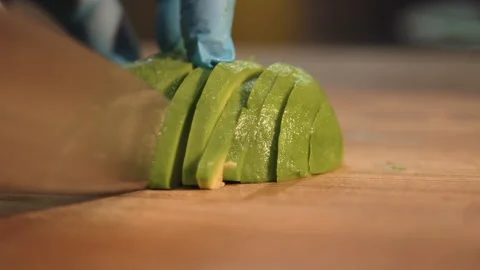 Chef slices avocado for salad Stock Footage 158021792