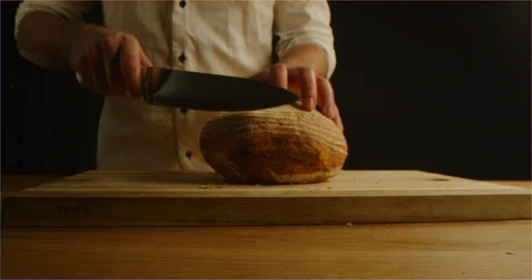 Chef slices brown bread with cereals macro shot Vídeo Stock 126295728