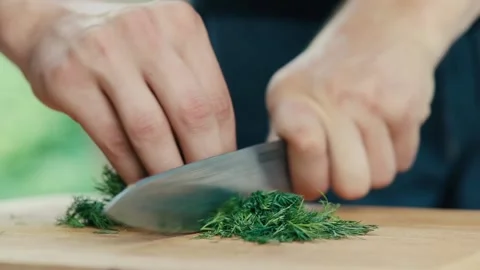 Chef slices dill with a knife close-up Stock Footage 130895334