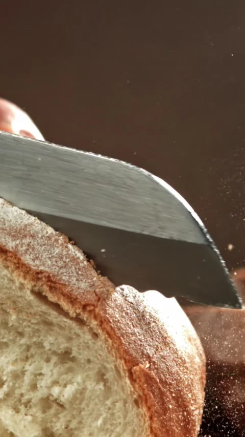 The chef slices fresh bread. Filmed on a high-speed camera at 1000 fps Stock Footage 335362914