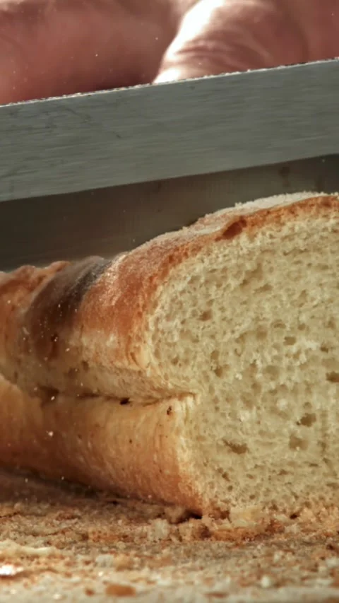 The chef slices fresh bread. Filmed on a high-speed camera at 1000 fps Stock Footage 335363553