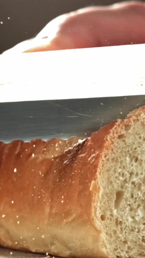 The chef slices fresh bread. Filmed on a high-speed camera at 1000 fps Stock Footage 335366097