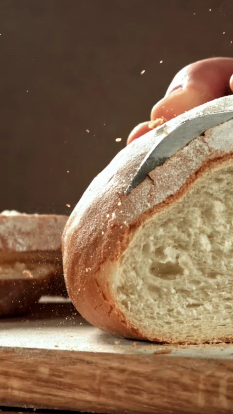 The chef slices fresh bread. Filmed on a high-speed camera at 1000 fps Stock Footage 335366880