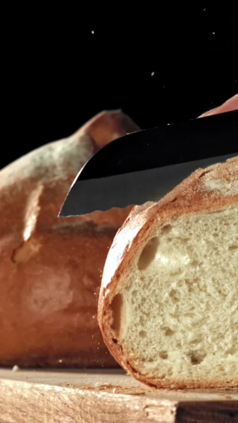 The chef slices fresh bread. Filmed on a high-speed camera at 1000 fps Stock Footage 335369364