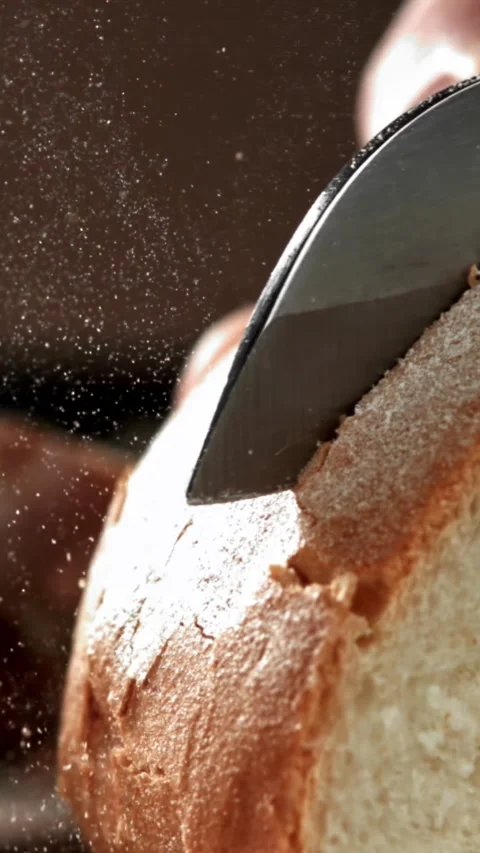 The chef slices fresh bread. Filmed on a high-speed camera at 1000 fps Stock Footage 335372939
