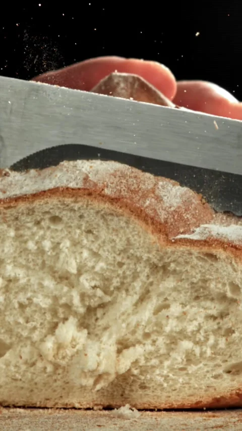 The chef slices fresh bread. Filmed on a high-speed camera at 1000 fps Stock Footage 335377785