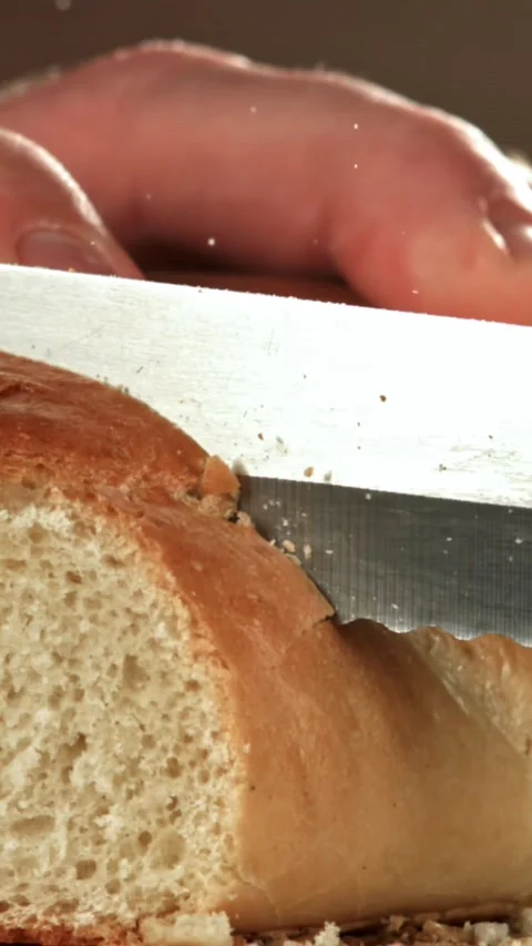 The chef slices fresh bread. Filmed on a high-speed camera at 1000 fps Stock Footage 335384191