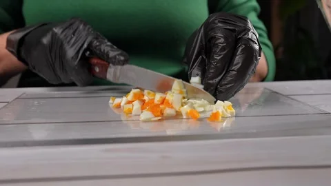 The chef slices hard-boiled eggs for the olivier salad. High quality 4k footage Vidéo 291684926