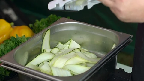 Chef slices his courgette vegetable for an amazing meal. Handheld shot Stock-Footage 109503699