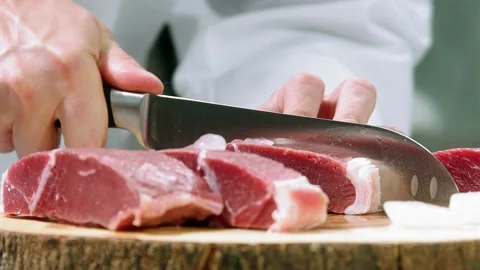 Chef slices meat Stock Footage 233004833
