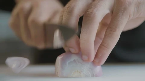 Chef slices onions with sharp knife. Slow Motion Video Stock Footage 103224578