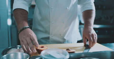 Chef slices peach with precision Stock Footage 204972939
