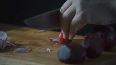 Chef slices radish on a cutting board in a restaurant. Prepare food. Stock-Footage 124756509