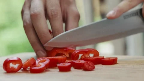 Chef slices red pepper close up of hand and knife full HD video Stock Footage 130769479