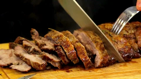 Chef slices roasted pork meat roll on wooden board Stock-Footage 333831446