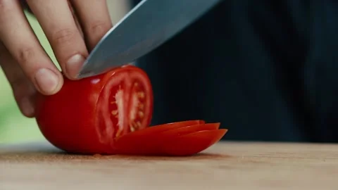 Chef slices tomato close up of hand and knife full HD video Stock Footage 130790580