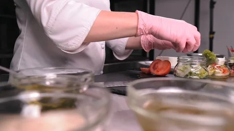 Chef slices tomatoes on a board Stock Footage 124167583