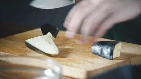 Chef slices vegetables on a cutting board in a restaurant. Stock-Footage 124749719