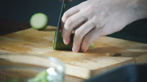 Chef slices vegetables on a cutting board in a restaurant. 스톡 동영상 124749849